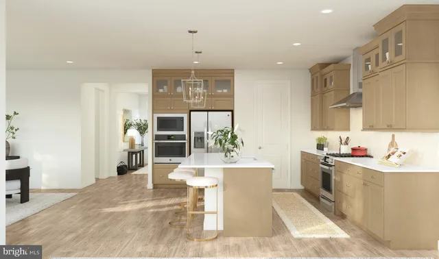 a living room with stainless steel appliances kitchen island granite countertop a sink and cabinets