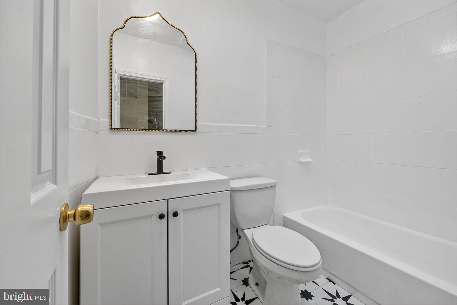 833 L Street Northeast Washington, DC 20002 - Photo 13 of 13 a bathroom with a sink toilet and a mirror