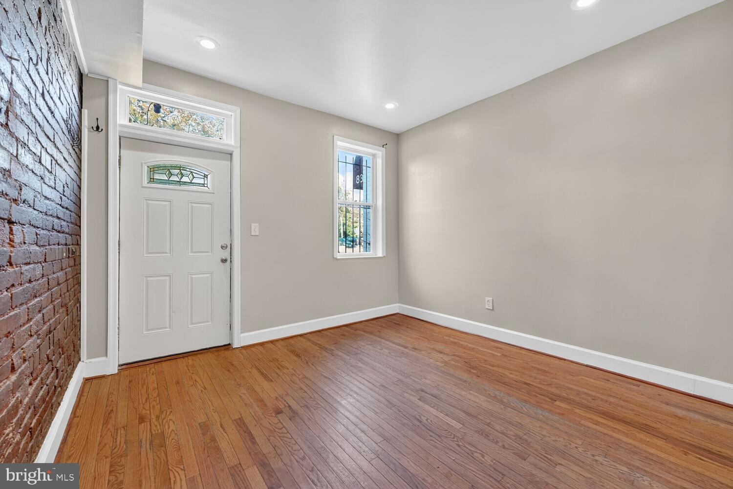 833 L Street Northeast Washington, DC 20002 - Photo 2 of 13 an empty room with wooden floor and windows