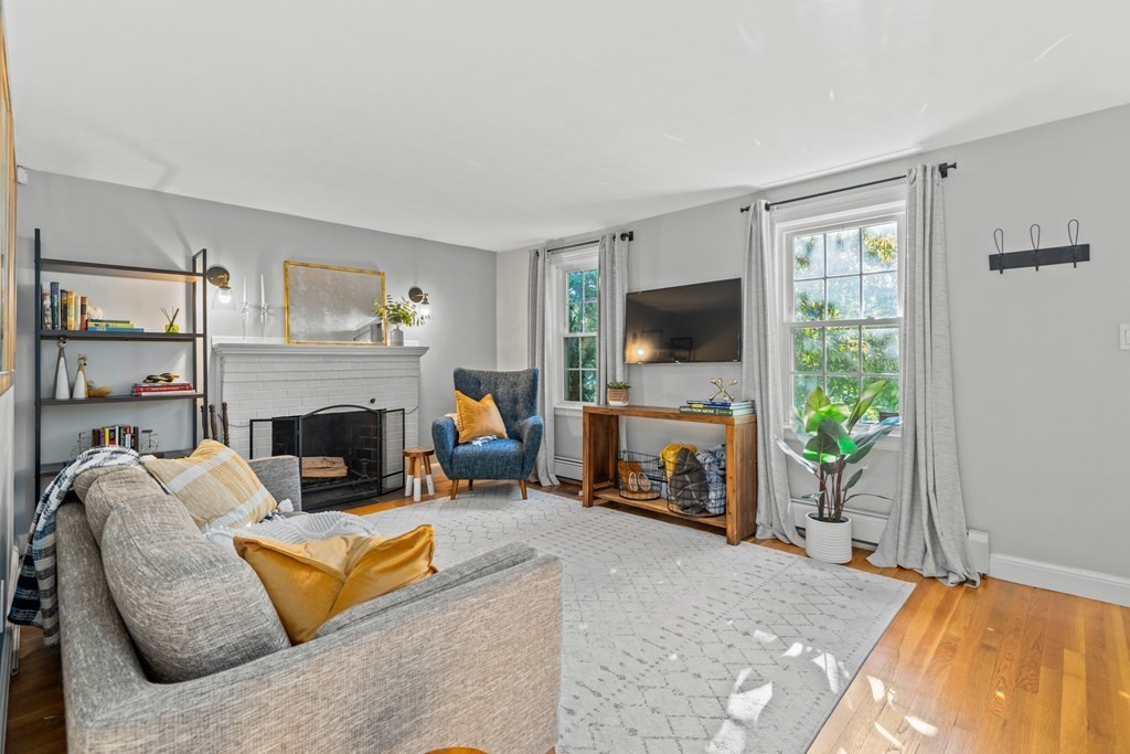 3 Castle Avenue Medfield, MA 02052 - Photo 2 of 36 a living room with furniture a flat screen tv and a fireplace