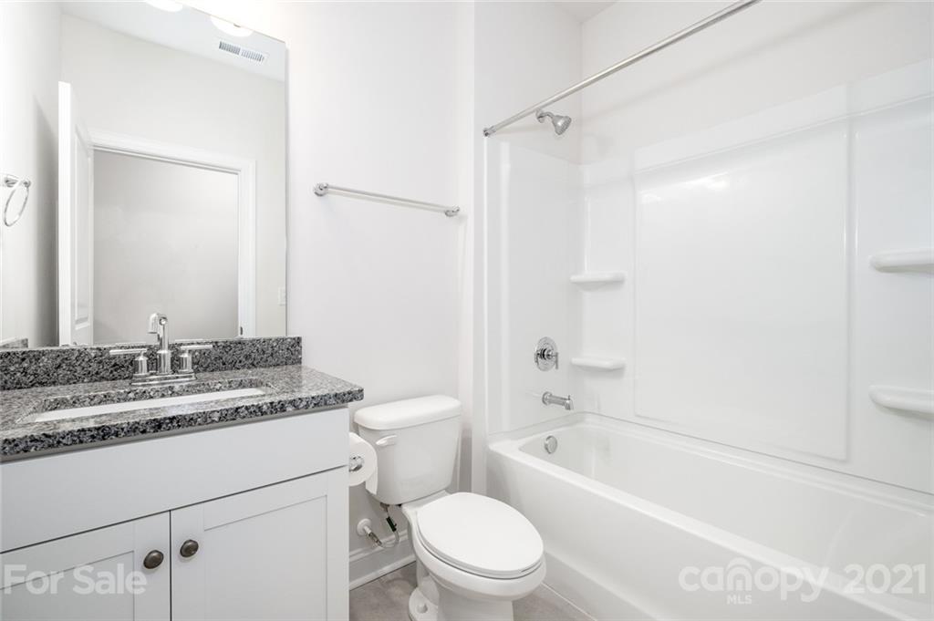420 Preston Road Mooresville, NC 28117 - Photo 14 of 39 a bathroom with a granite countertop sink toilet mirror and bathtub