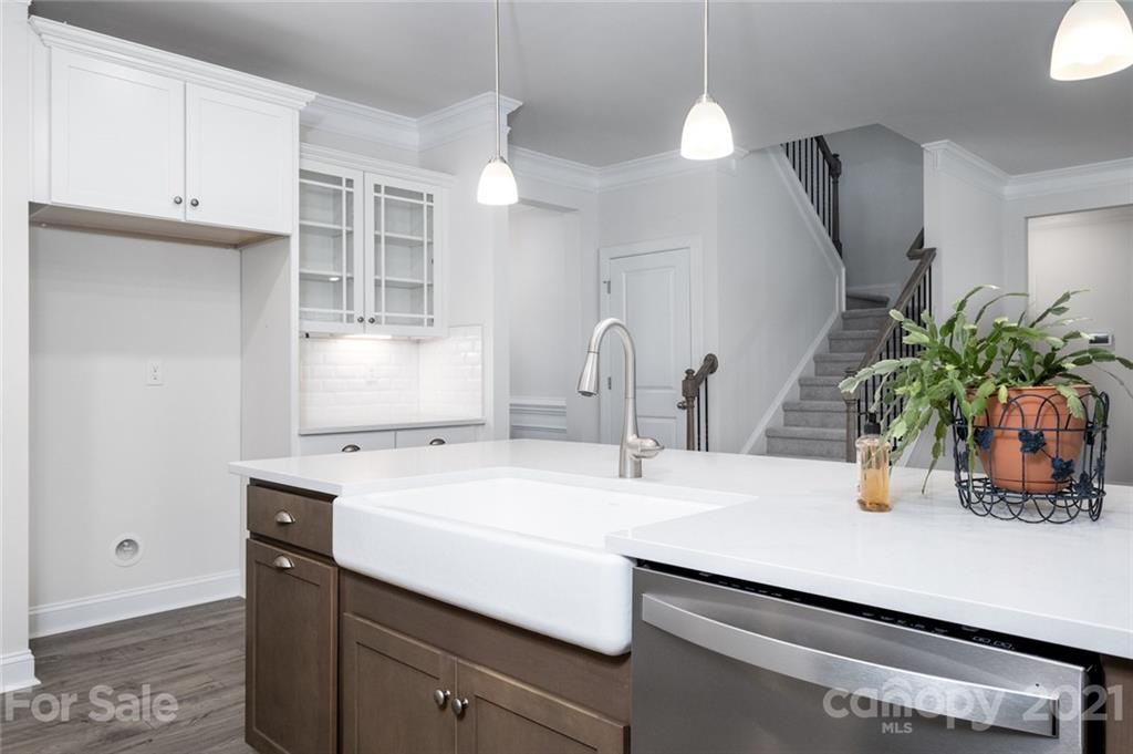 420 Preston Road Mooresville, NC 28117 - Photo 16 of 39 a kitchen with a sink a potted plant and cabinets