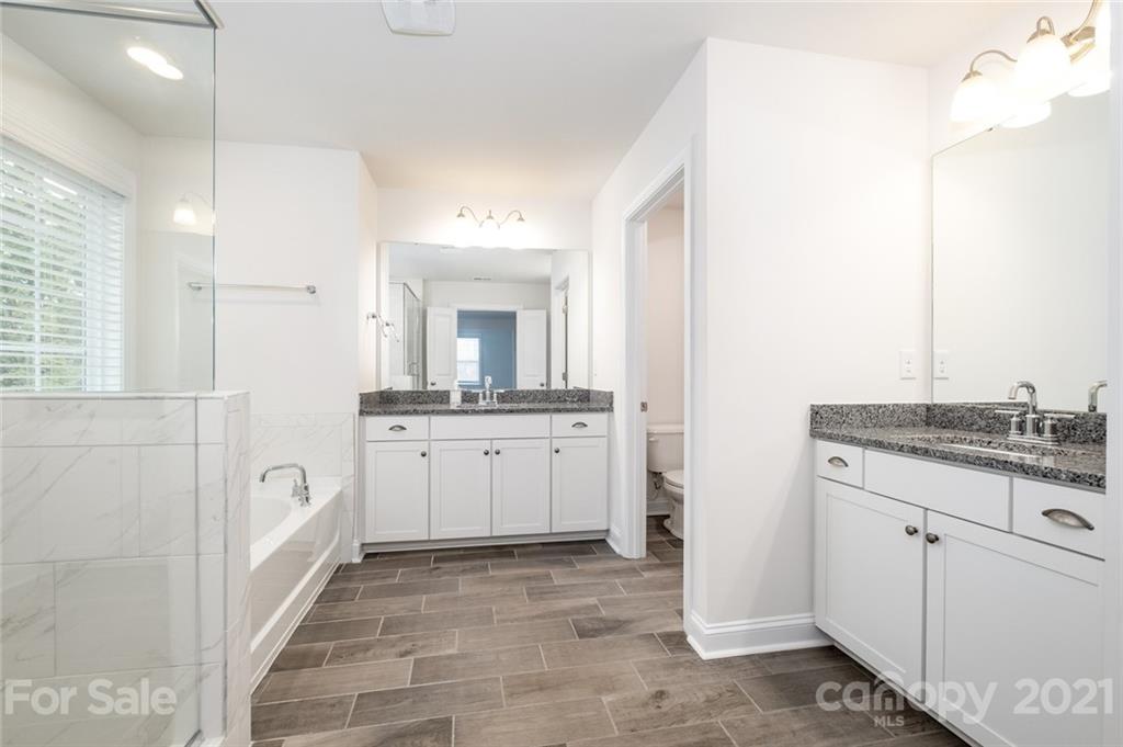 420 Preston Road Mooresville, NC 28117 - Photo 23 of 39 a bathroom with a granite countertop sink mirror and bathtub