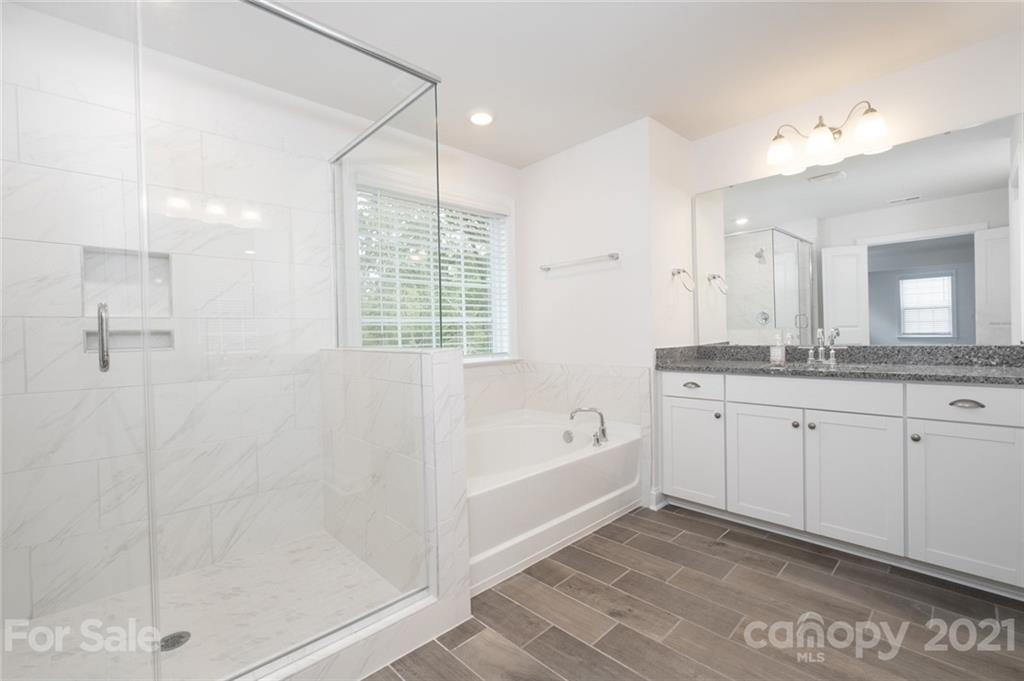 420 Preston Road Mooresville, NC 28117 - Photo 24 of 39 a spacious bathroom with double vanity a mirror a bathtub and shower