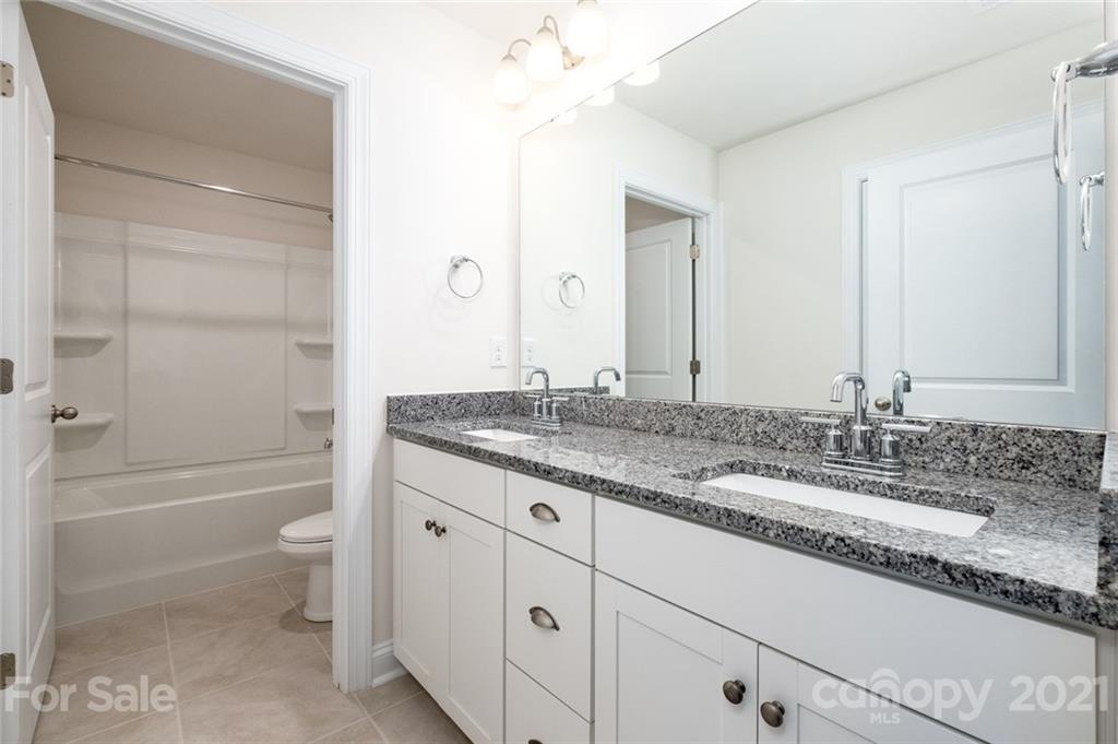 420 Preston Road Mooresville, NC 28117 - Photo 28 of 39 a bathroom with a granite countertop sink toilet and shower