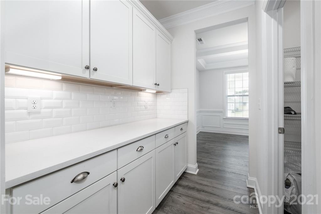 420 Preston Road Mooresville, NC 28117 - Photo 5 of 39 a kitchen with granite countertop white cabinets and white appliances