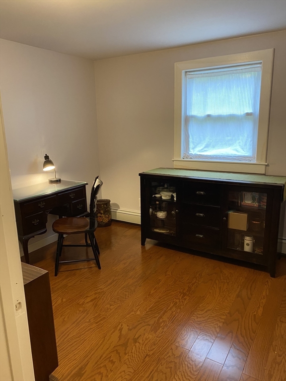 616 County Road Barrington, RI 02806 - Photo 24 of 32 a living room with a table and a fireplace