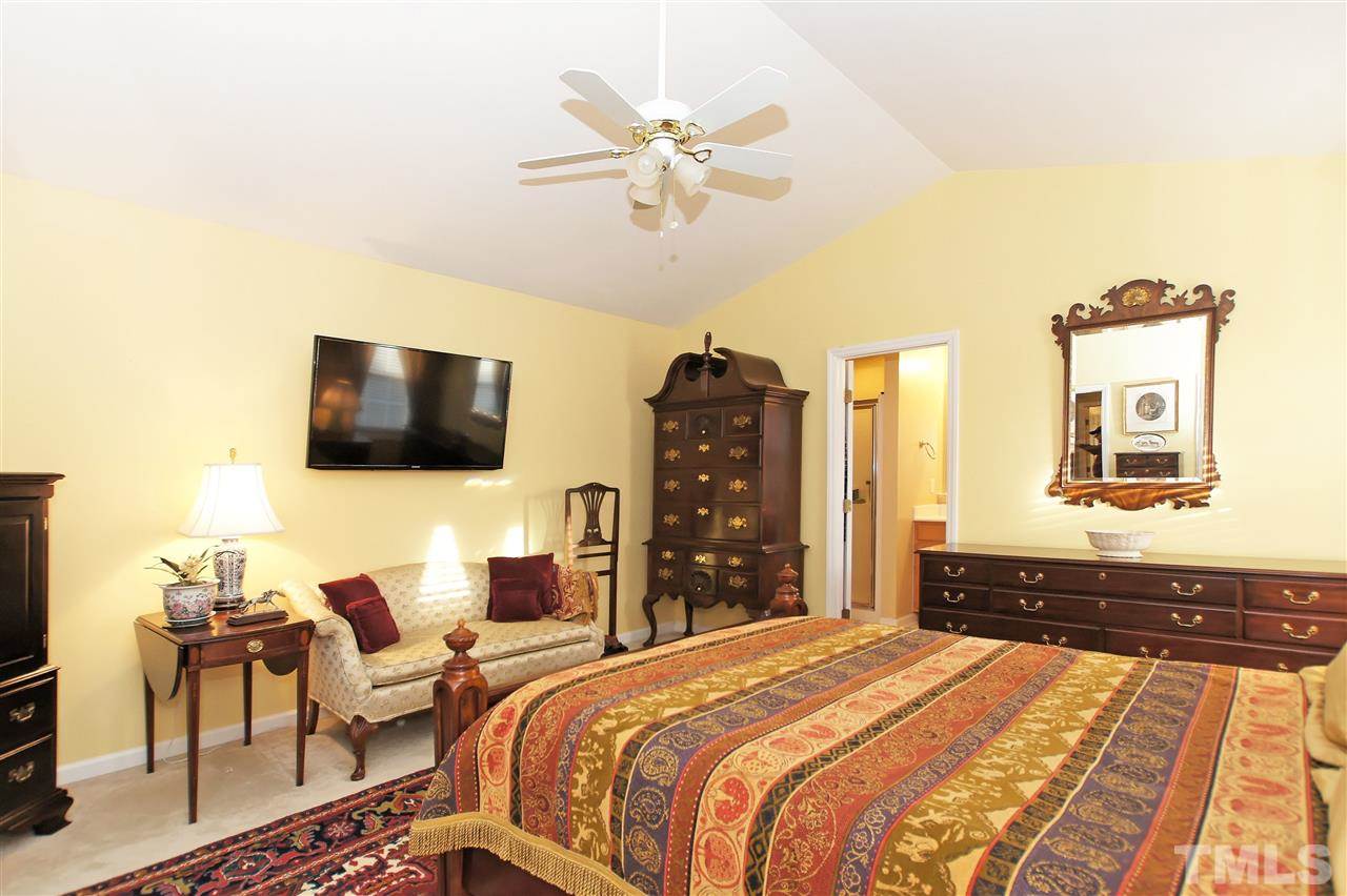 113 Inkster Cove Raleigh, NC 27603 - Photo 14 of 24 a bedroom with a bed and a flat screen tv