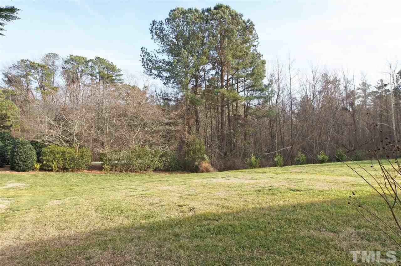 113 Inkster Cove Raleigh, NC 27603 - Photo 22 of 24 a view of pool with trees in the background