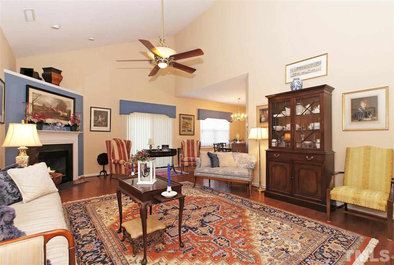 113 Inkster Cove Raleigh, NC 27603 - Photo 4 of 24 a living room with fireplace furniture and a rug
