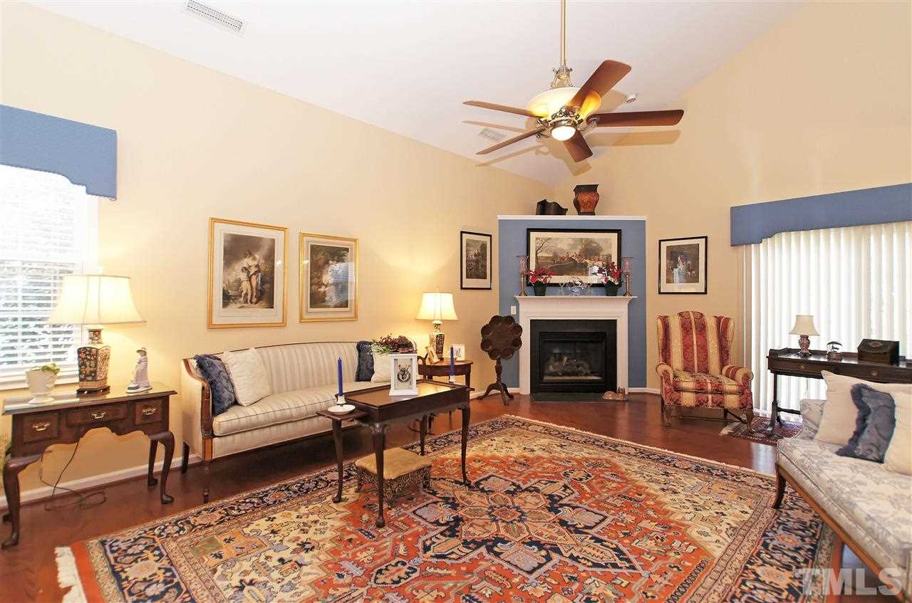 113 Inkster Cove Raleigh, NC 27603 - Photo 5 of 24 a living room with furniture a window and a fireplace