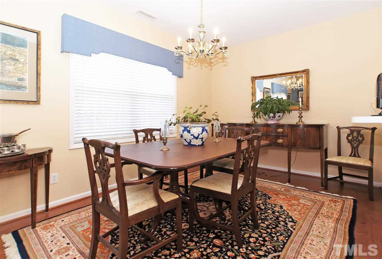 113 Inkster Cove Raleigh, NC 27603 - Photo 7 of 24 a view of a dining room with furniture and chandelier