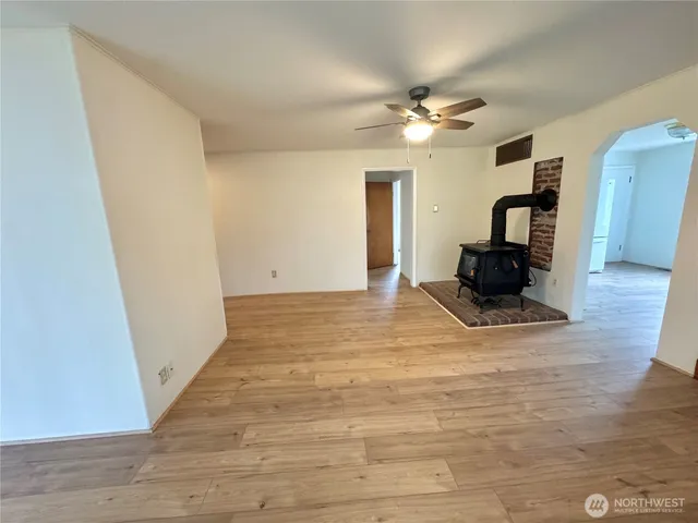 a view of a livingroom with wooden floor and a ceiling fan
