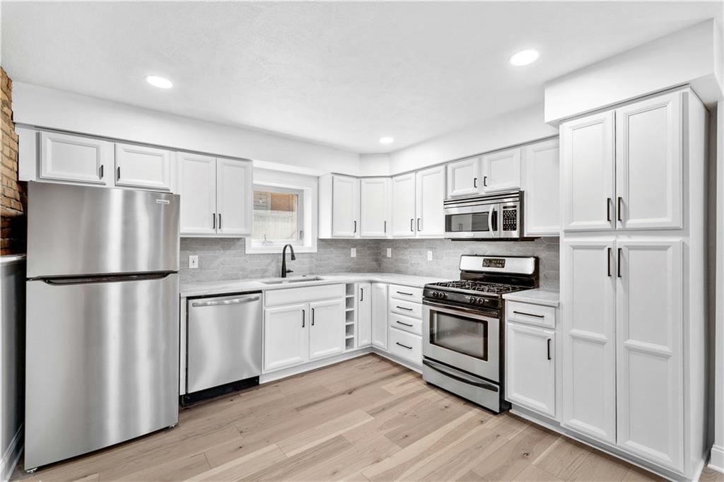 2128 Merriman Way Pittsburgh, PA 15203 - Photo 11 of 37 a kitchen with stainless steel appliances a refrigerator sink and microwave