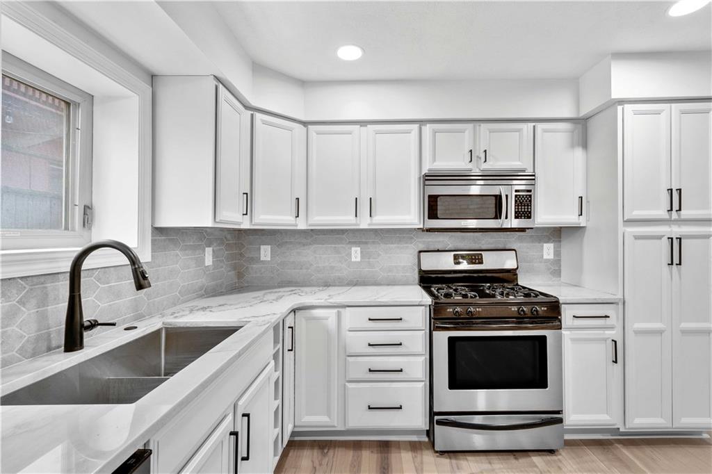 2128 Merriman Way Pittsburgh, PA 15203 - Photo 12 of 37 a kitchen with white cabinets stainless steel appliances and sink