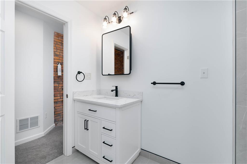 2128 Merriman Way Pittsburgh, PA 15203 - Photo 24 of 37 a bathroom with a sink and a mirror