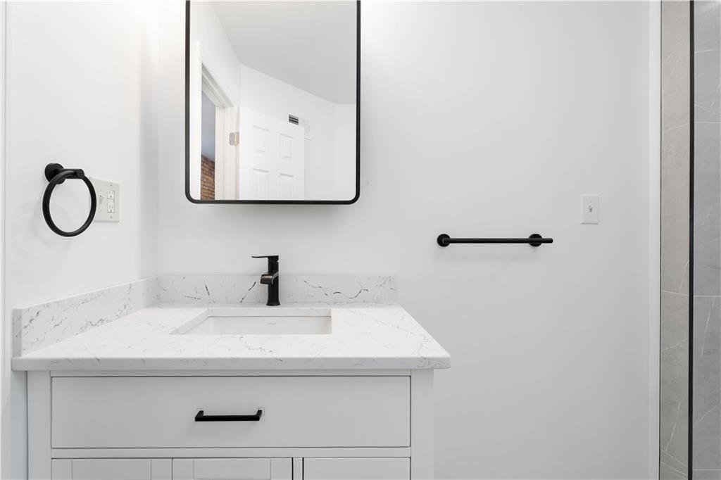 2128 Merriman Way Pittsburgh, PA 15203 - Photo 25 of 37 a bathroom with a sink and a mirror