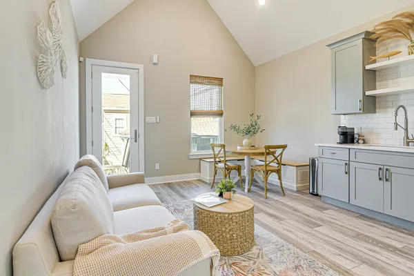 a living room with furniture a dining table and a window