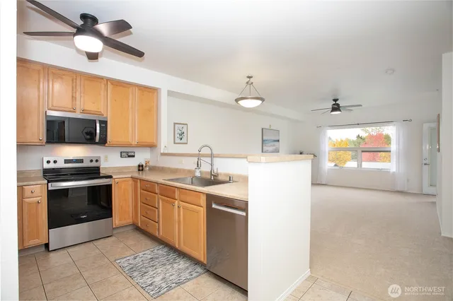a kitchen with stainless steel appliances granite countertop a sink and a stove