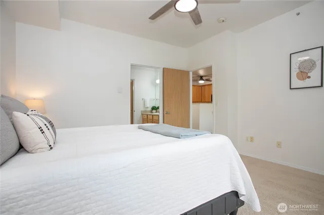 a bedroom with a large bed and a chandelier