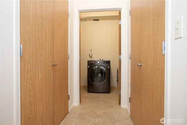 a view of a bedroom with washer and dryer
