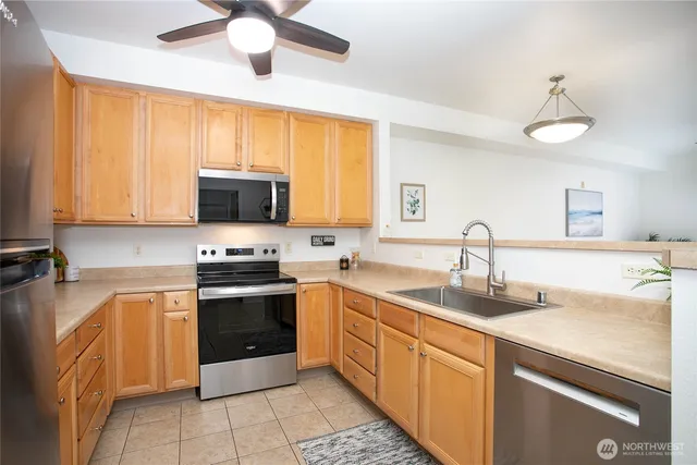a kitchen with a sink stove and microwave