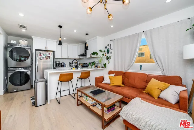 a living room with furniture a air conditioner and a window