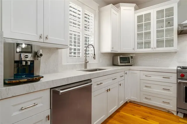 a spacious bedroom with a bed and a chandelier