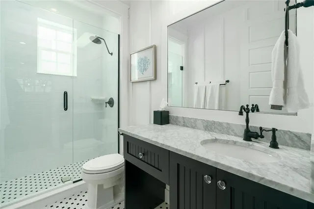 a white toilet sitting next to a bathroom sink