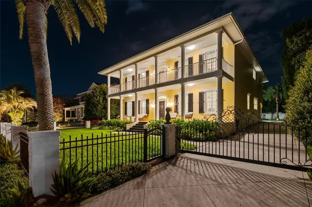 a view of a brick house with wooden fence