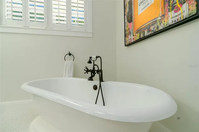 a view of a house with a yard and palm trees