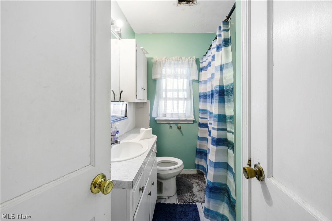 4001 South Cleveland Massillon Road Barberton, OH 44203 - Photo 20 of 25 Full bathroom featuring vanity and a shower with curtain
