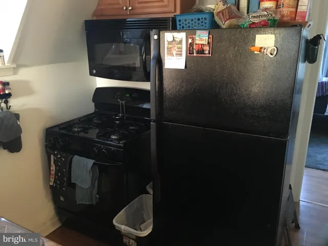 a kitchen with granite countertop a sink a stove and cabinets