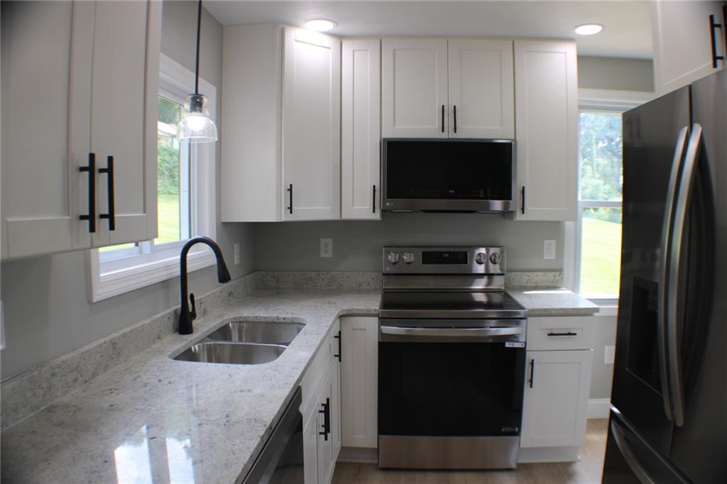 135 Truver Road Valencia, PA 16059 - Photo 3 of 36 Brand new kitchen with granite, white cabinets and stainless steel appliances.