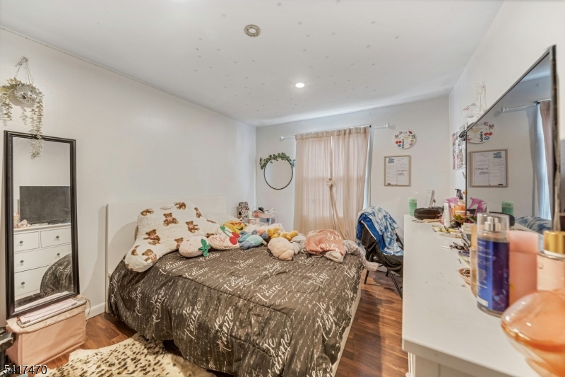 13 Allen Street Passaic, NJ 07055 - Photo 3 of 7 a bedroom with furniture and wooden floor