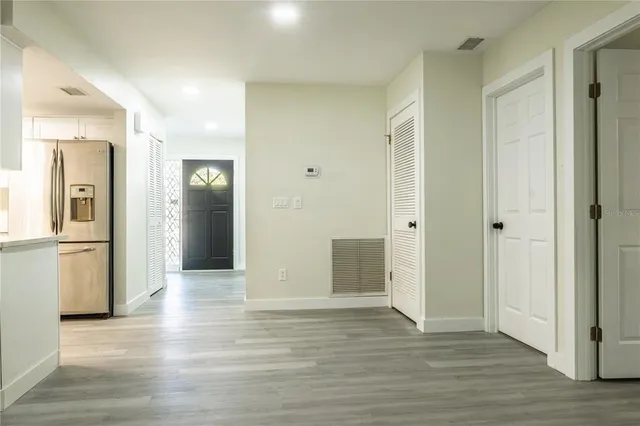 a view of an empty room with window and a fireplace