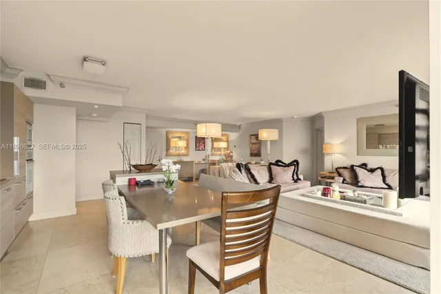 a large white room with a couch and a table chair