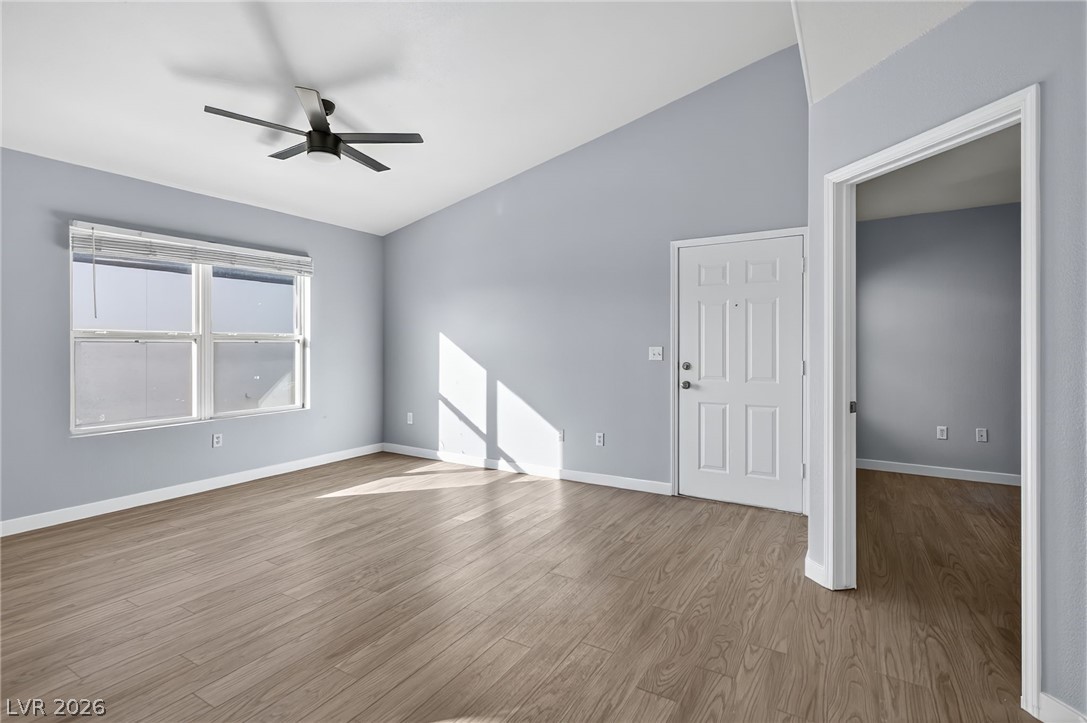 7255 West Sunset Road, Unit 2144 Las Vegas, NV 89113 - Photo 2 of 23 Unfurnished living room with light wood finished floors and ceiling fan