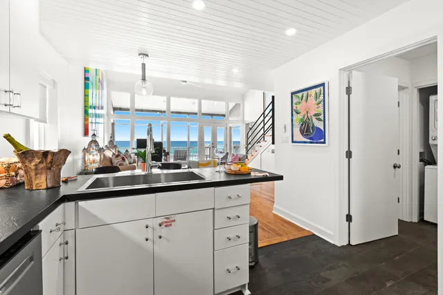a kitchen with sink and cabinets