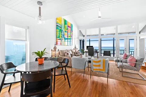 a living room with fireplace furniture and a wooden floor