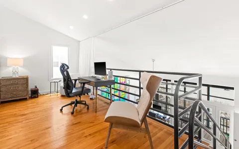a view of a livingroom with workspace and a couch