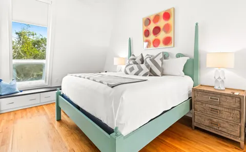 a bed room with a bed and a window