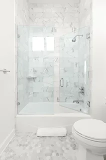 a bathroom with a bathtub and a toilet