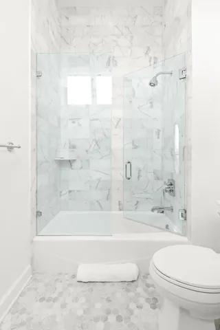 a bathroom with a bathtub and a toilet