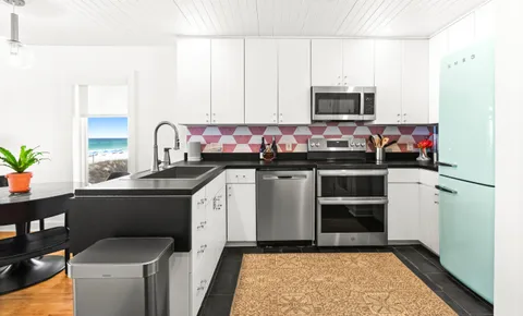 a kitchen with a sink stove and microwave