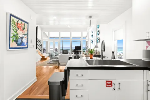 a view of living room with kitchen island furniture and a window