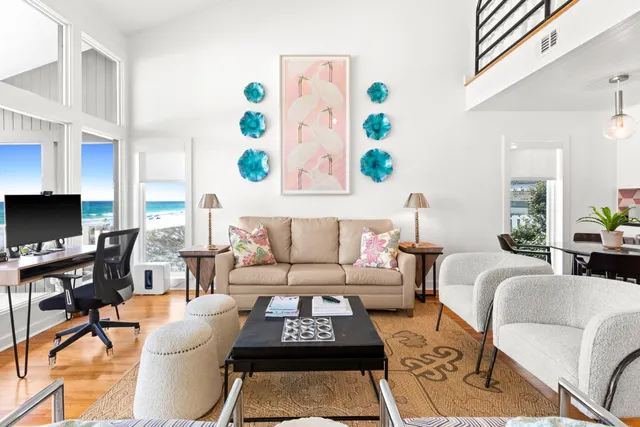 a living room with furniture a rug and a flat screen tv