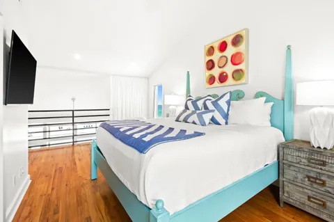 a bedroom with a bed and a flat screen tv