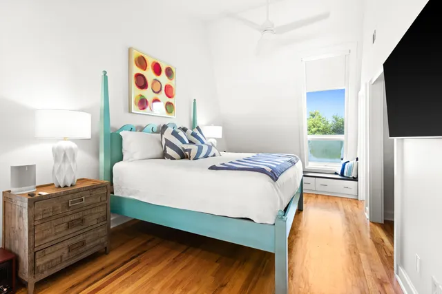 a bedroom with a bed and a flat screen tv