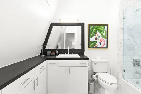a view of bathroom with a toilet sink and mirror